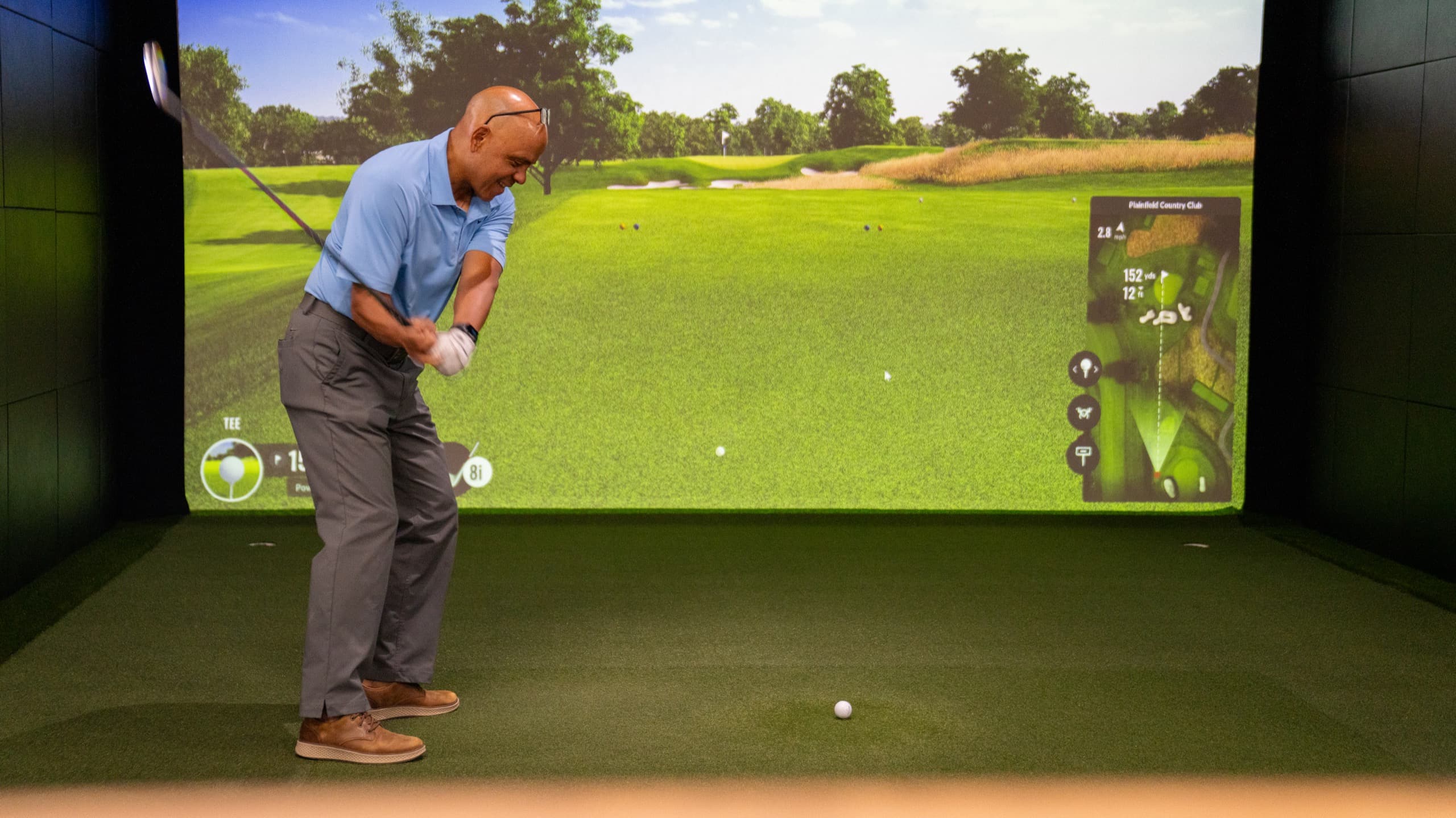 Jorge Diaz, PGA mid-swing in the simulator bay at Unbound Golf in Branchburg, NJ